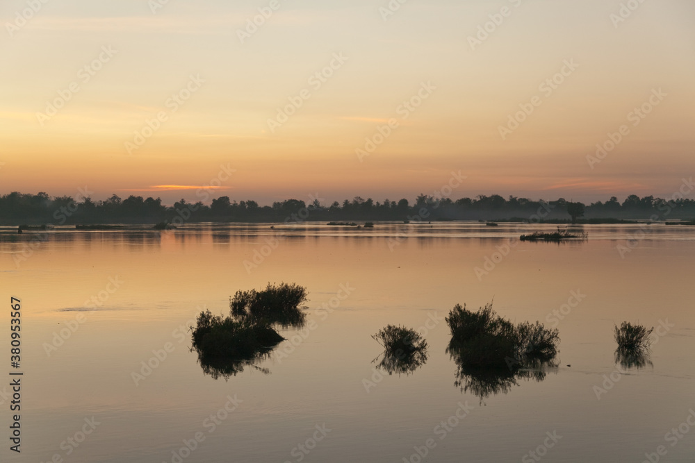 Muong Khong Laos 1/12/2012 Mekong river at dawn with golden sun rise over water