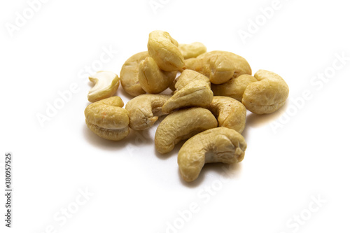 Large pile of cashew nuts on white isolated background macro photo