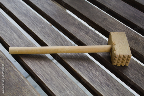 Wooden hammer for culinary use on a table