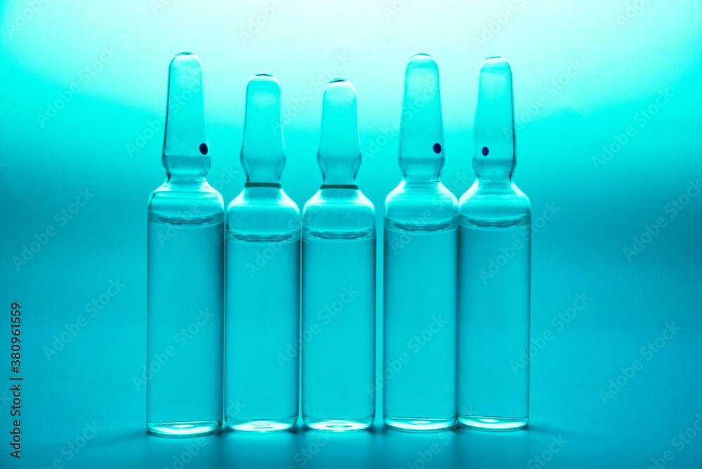 glass ampoules with liquid medicine in blue light glass ampoules with liquid medicine in blue light