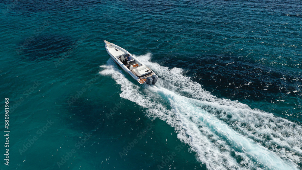 Aerial drone photo of luxury inflatable speed boat cruising in deep blue Aegean sea, Mykonos island, Cyclades, Greece Aerial drone photo of luxury inflatable speed boat cruising in deep blue Aegean sea, Mykonos island, Cyclades, Greece
