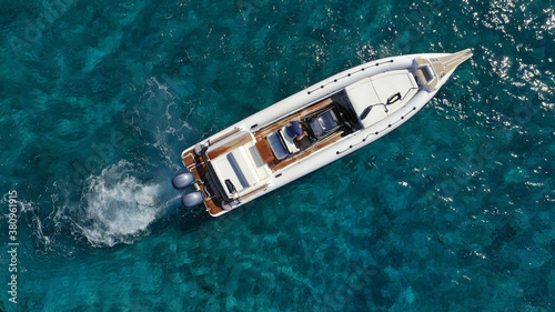 Aerial drone photo of luxury inflatable speed boat cruising in deep blue Aegean sea, Mykonos island, Cyclades, Greece