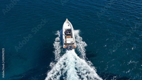 Aerial drone photo of luxury inflatable speed boat cruising in deep blue Aegean sea, Mykonos island, Cyclades, Greece © aerial-drone
