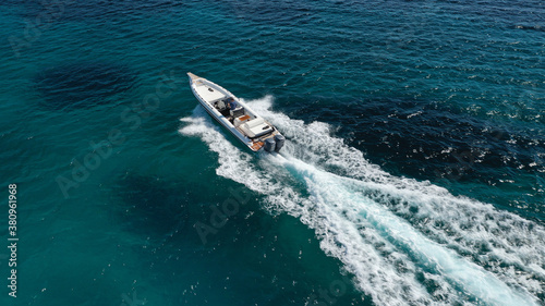 Aerial drone photo of luxury inflatable speed boat cruising in deep blue Aegean sea, Mykonos island, Cyclades, Greece