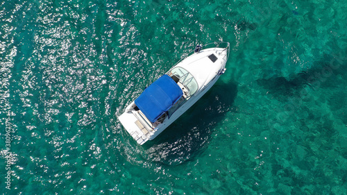 Aerial drone photo of luxury power boat cruising in deep blue sea near Mediterranean Aegean island © aerial-drone