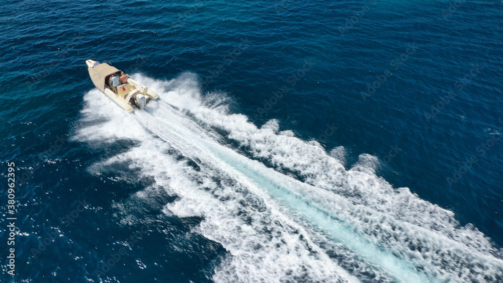 Aerial drone photo of luxury inflatable speed boat cruising in deep blue Aegean sea, Mykonos island, Cyclades, Greece Aerial drone photo of luxury inflatable speed boat cruising in deep blue Aegean sea, Mykonos island, Cyclades, Greece