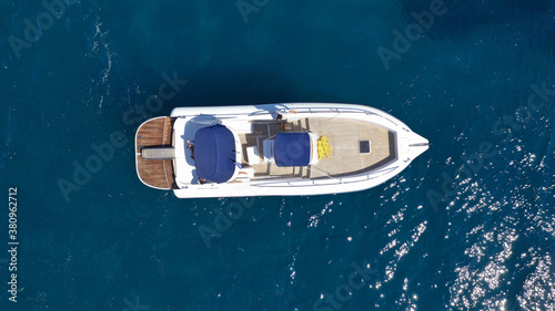 Aerial drone top down photo of luxury inflatable rib boat anchored in tropical exotic bay with emerald sea