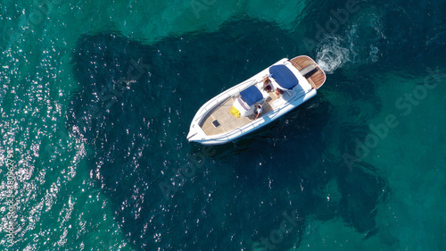 Aerial drone top down photo of luxury inflatable rib boat anchored in tropical exotic bay with emerald sea © aerial-drone
