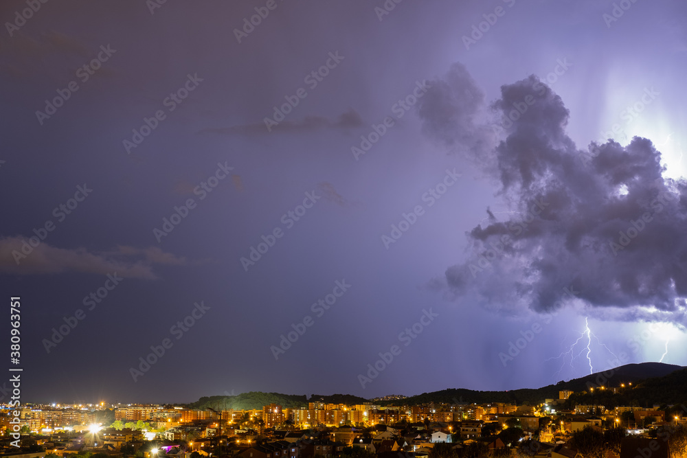 The lightning in the night sky over the city.