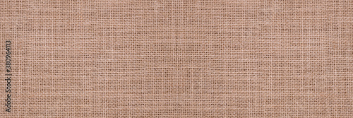 Rough hessian background with flecks of varying colors of beige and brown. with copy space. office desk concept, Hessian sackcloth burlap woven texture background..