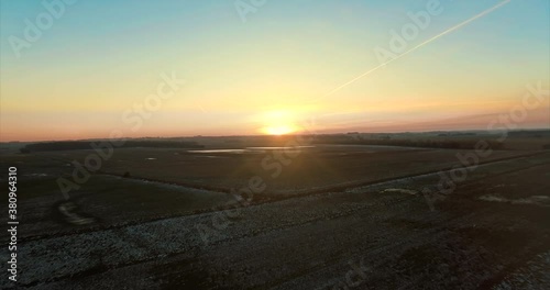 Sunset over frozen scandinavian fields. photo