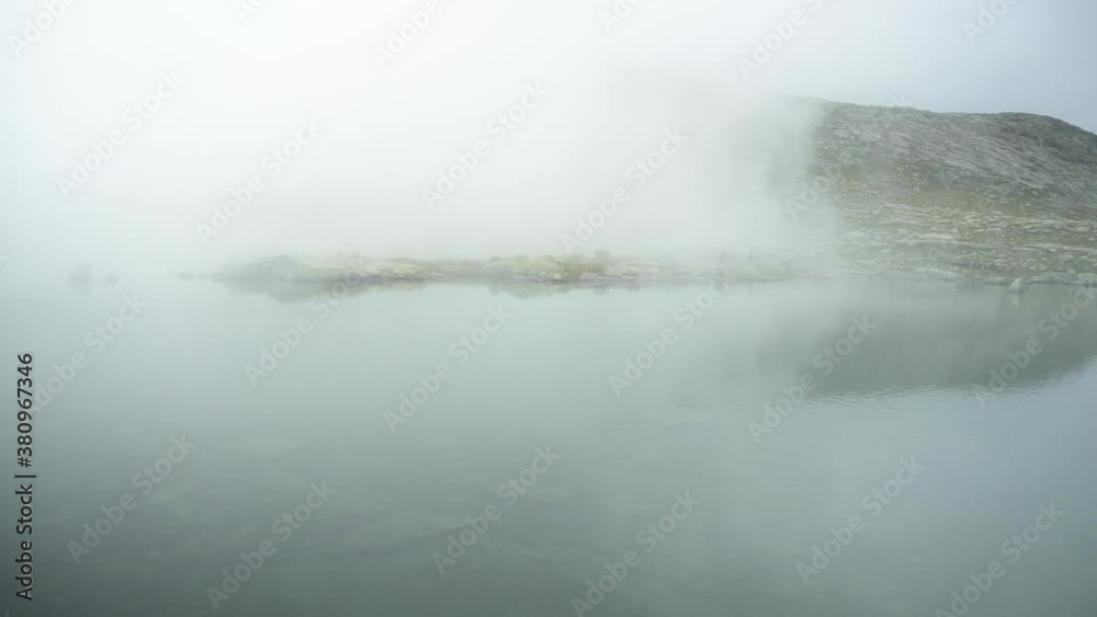 Foggy lake at Trolltunga trail in Norway, North West area Telemark. Foggy lake at Trolltunga trail in Norway, North West area Telemark.