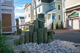 Beach Pilings in a Rock Bed in the Yard of a Shore House