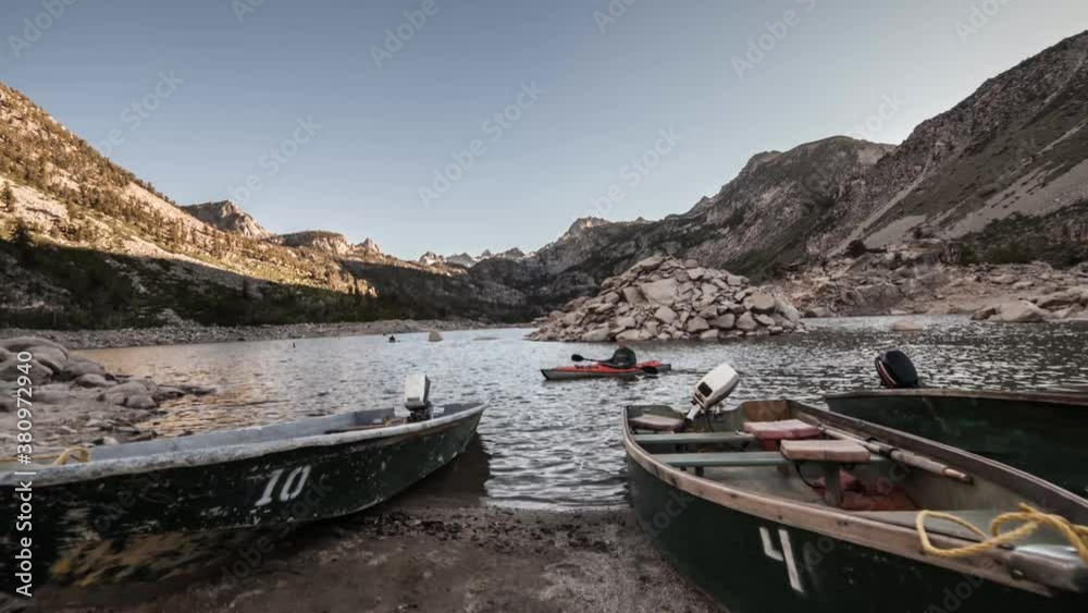 Time-lapse of canoes and kayaking in a mountainous river setting Time-lapse of canoes and kayaking in a mountainous river setting