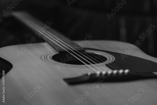 Details of an acoustic guitar, detailed photos of a guitar, guitar strings and soundhole, abstract, blurring, macro photo, black and white photo photo