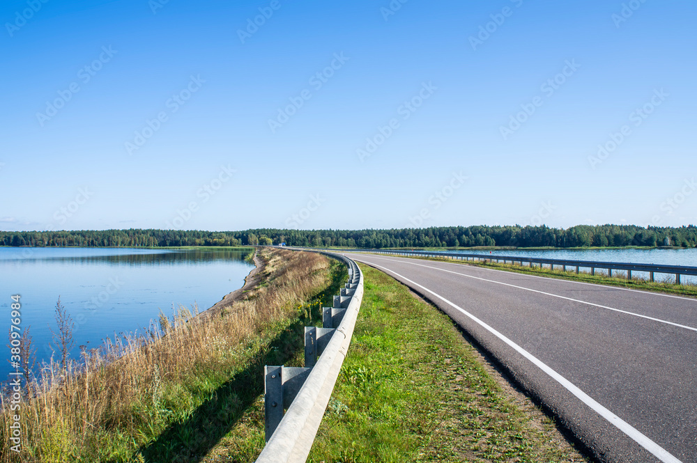 A beautiful automobile asphalt road without cars and people. A beautiful automobile asphalt road without cars and people.