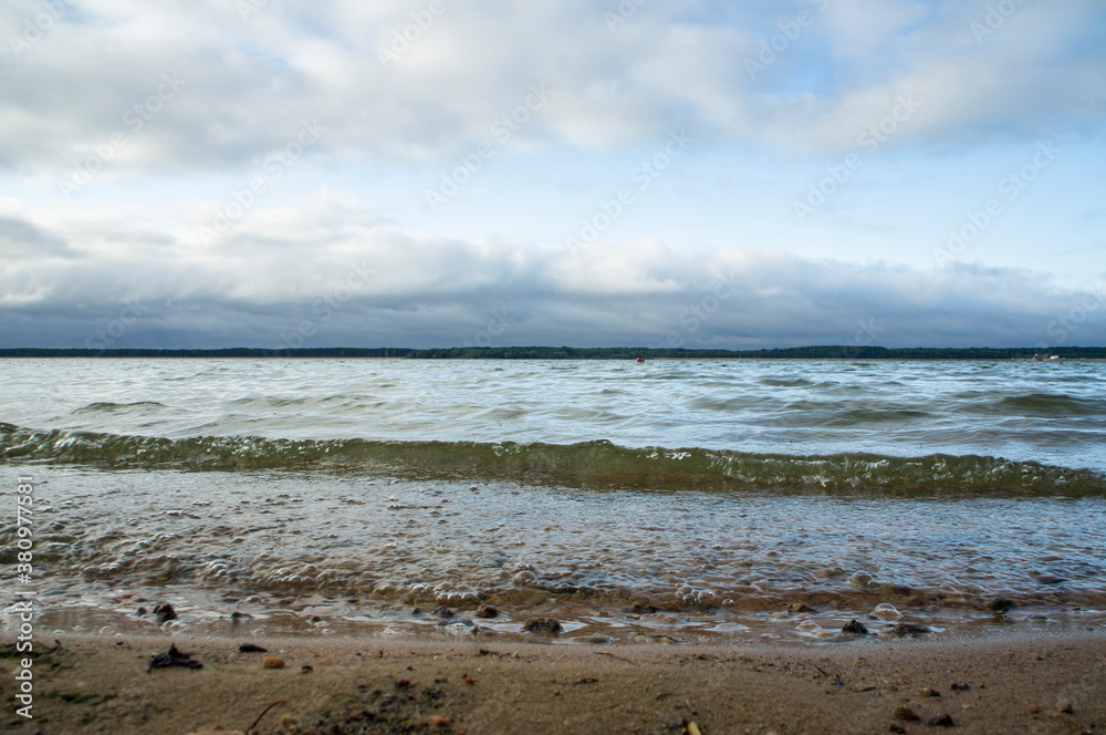 Landscape with waves near the lake shore Landscape with waves near the lake shore