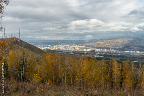 A beautiful view opens from one of the hills in the vicinity of Krasnoyarsk to the city and the golden autumn.