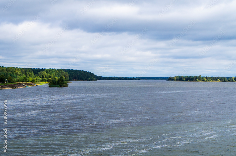 Landscape overlooking the lake with a forest shore