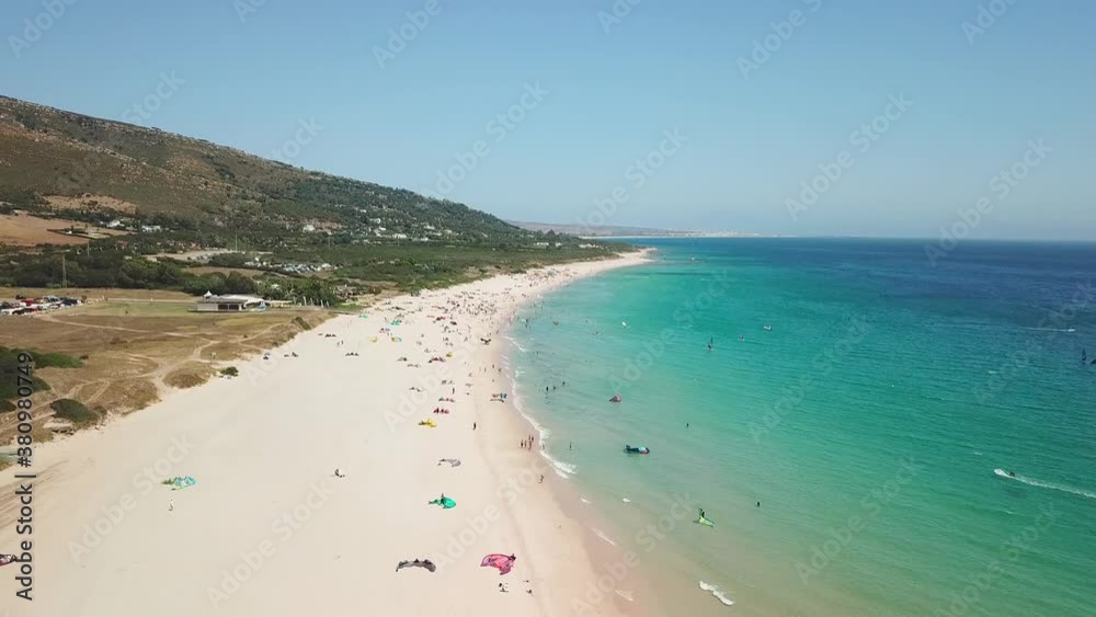 Beautiful drone view of Punta Paloma beach in Tarifa city - Cadiz. Unique and famous destination, in south of Spain , for water sport. People enjoying summer and waves. Drone rotating left and forward Beautiful drone view of Punta Paloma beach in Tarifa city - Cadiz. Unique and famous destination, in south of Spain , for water sport. People enjoying summer and waves. Drone rotating left and forward