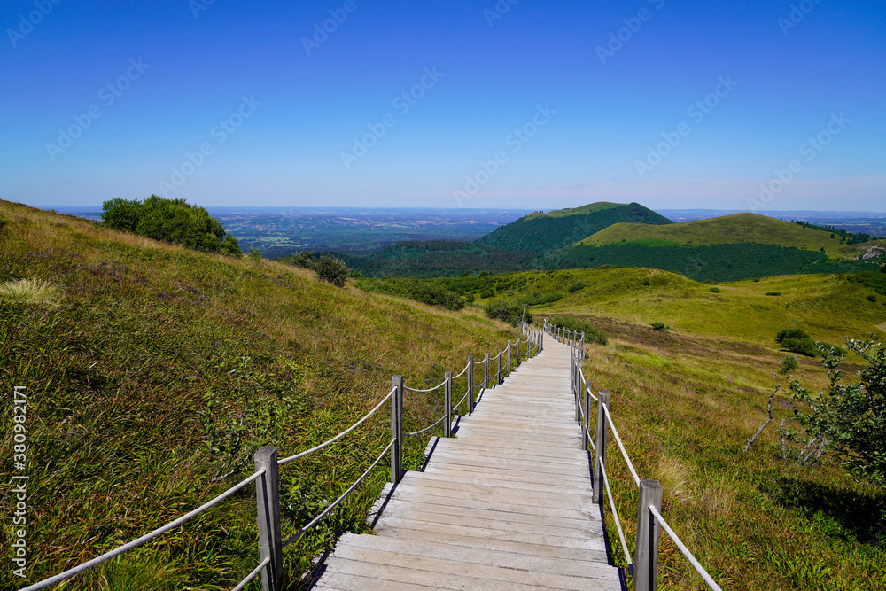 wooden pathway tourist staircase for access easy on hight mountain Puy de Dôme volcano in Auvergne france