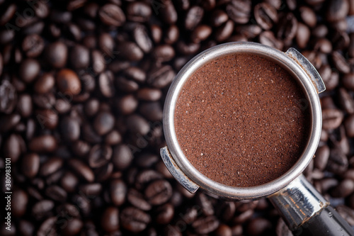 Filter holder with ground coffee and roasted coffee beans .