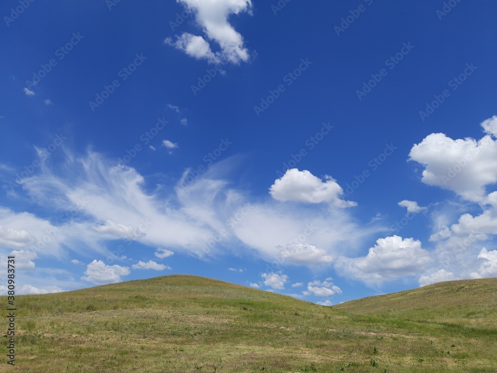 Hills, clouds and blue sky