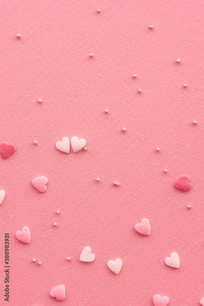 Candies hearts on pink and white paper. Flat lay for Valentine’s Day. Creative sweet concept. Background, top view Candies hearts on pink and white paper. Flat lay for Valentine’s Day. Creative sweet concept. Background, top view