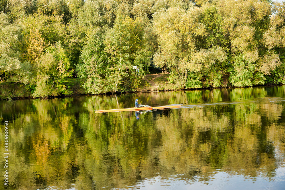 Sportsman kayaking on the river. Autumn landscape. Moscow river in Strogino, Moscow
