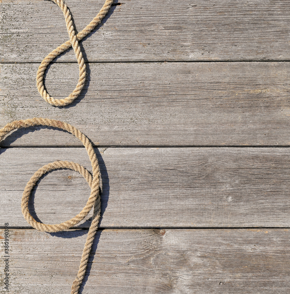 Fototapeta premium Ship rope on old wooden texture background with copy space
