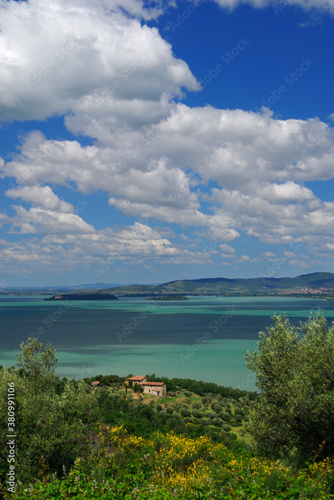 Hilltop view of sun dappled Lake Trasimeno in Umbria Italy