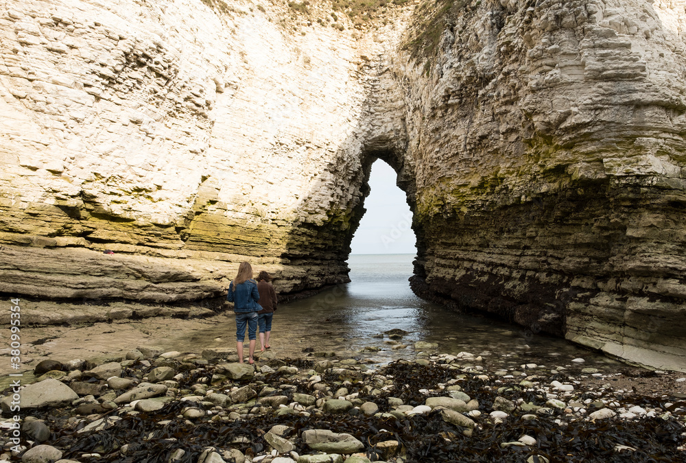 Two girls exploring a sea arch