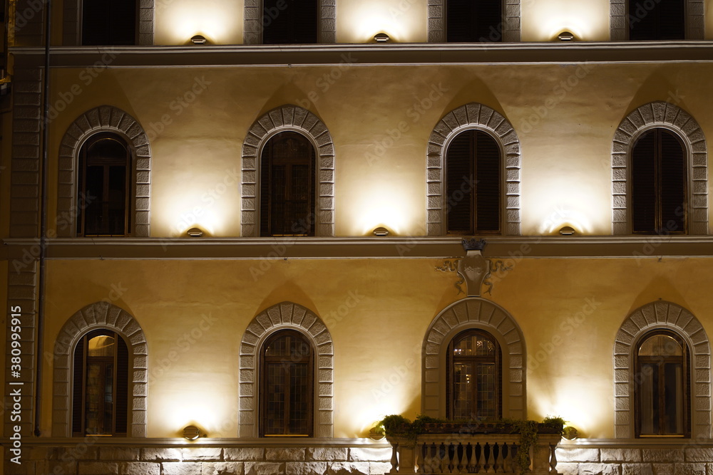 illuminated windows of historic building
