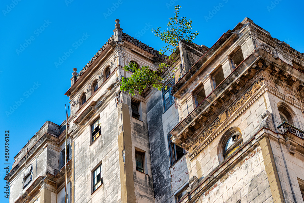 An old abandoned building with trees growing from it in Havana Cuba