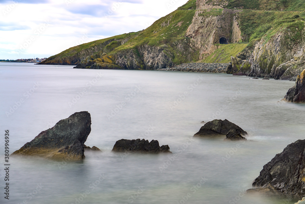 Fototapeta premium Bray to Greystones Cliff Walk. Long-exposure shot of coastal line in Bray, Co. Wicklow, Ireland 