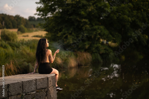 person sitting on the edge of the river