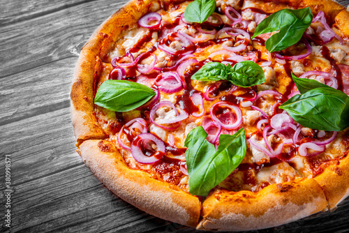 Pizza with chicken and barbeque sauce . Italian pizza on wooden table background 