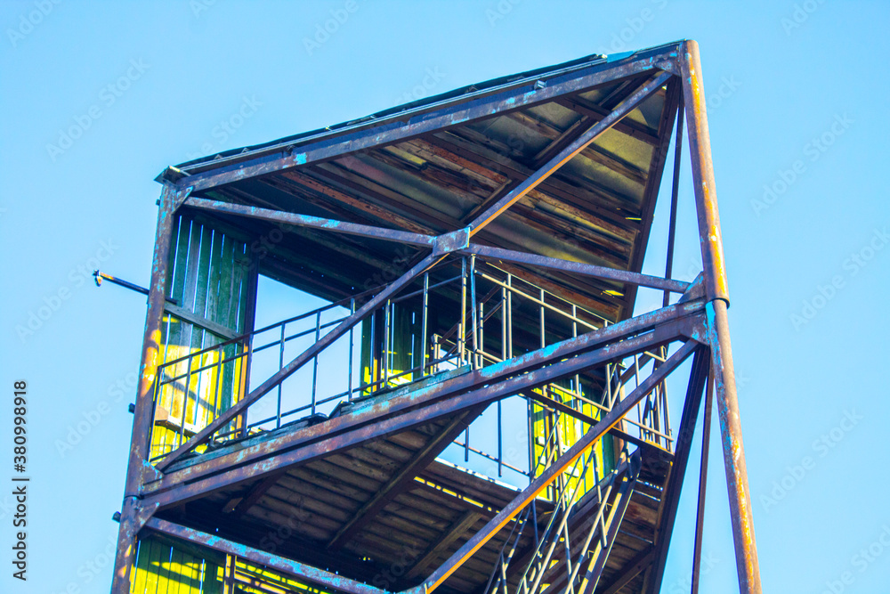 industrial old fire tower on blue sky background
