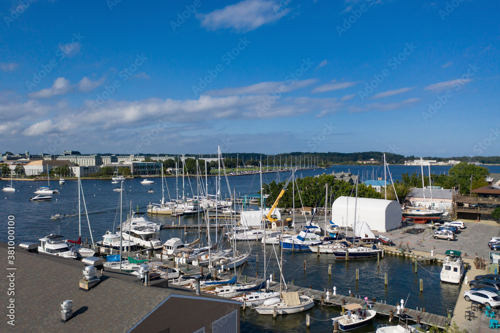 Aerial view of colorful sailboat moorings and docks on azure blue Spa Creek, in historic downtown Annapolis Maryland on a sunny summer day