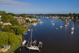 Aerial view of colorful sailboat moorings and docks surrounded by colorful residential rooftops on and azure blue Spa Creek, in historic downtown Annapolis Maryland on a sunny summer day