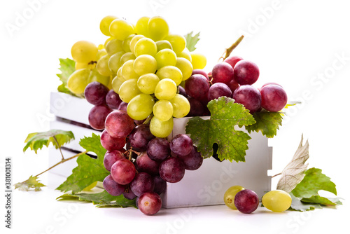 Green and pink grapes with leaves in a white box. isolate on white background
