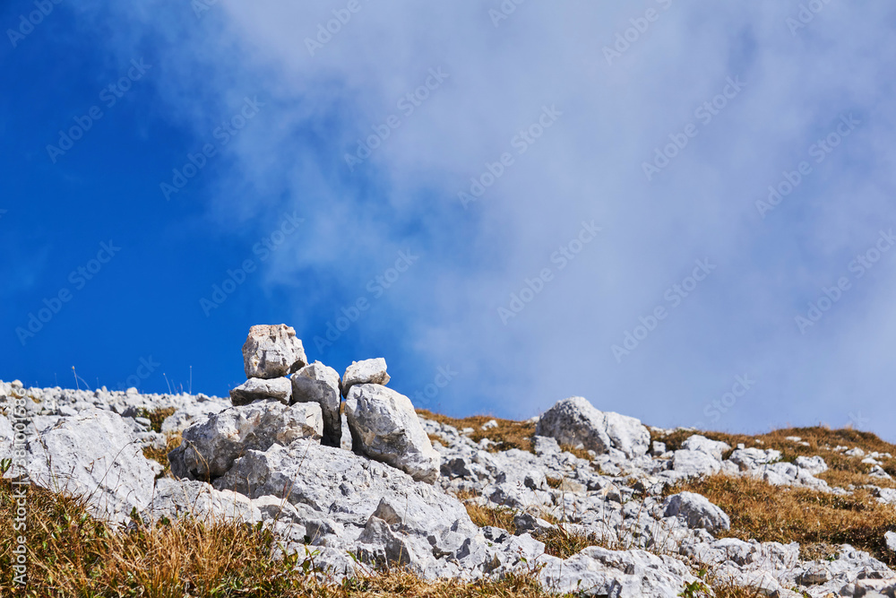 Fototapeta premium small cairn marks the path through the mountain pass