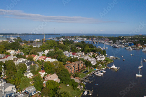 Aerial view of colorful sailboat moorings and docks surrounded by colorful residential rooftops on and azure blue Spa Creek, in historic downtown Annapolis Maryland on a sunny summer day