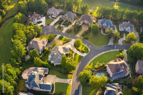 Aerial view of beautiful sub division in Suburbs of Georgia with golf course and lake shot during golden hour