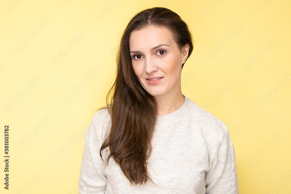 Happy attractive tatar young woman smiling and laughing isolated on yellow background with copy space, face portrait