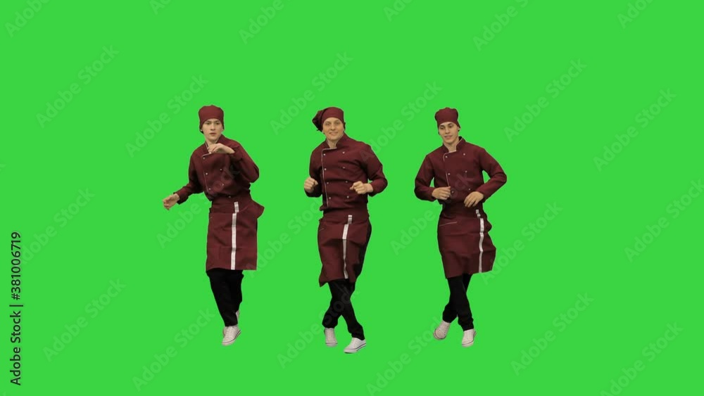 Three funny chef cooks in red uniform dancing against green background on a Green Screen, Chroma Key. Three funny chef cooks in red uniform dancing against green background on a Green Screen, Chroma Key.