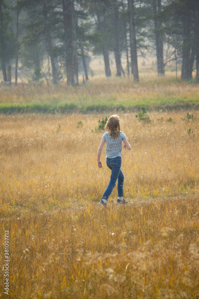 Young lady marching in to wood from. Growing sunlight hair