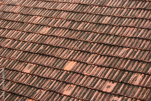 Texture of lines of terracotta tiles on the roof of a building