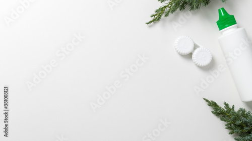 Contact lenses and lens solution on a white background