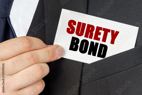 Businessman holds a card with the text - SURETY BOND